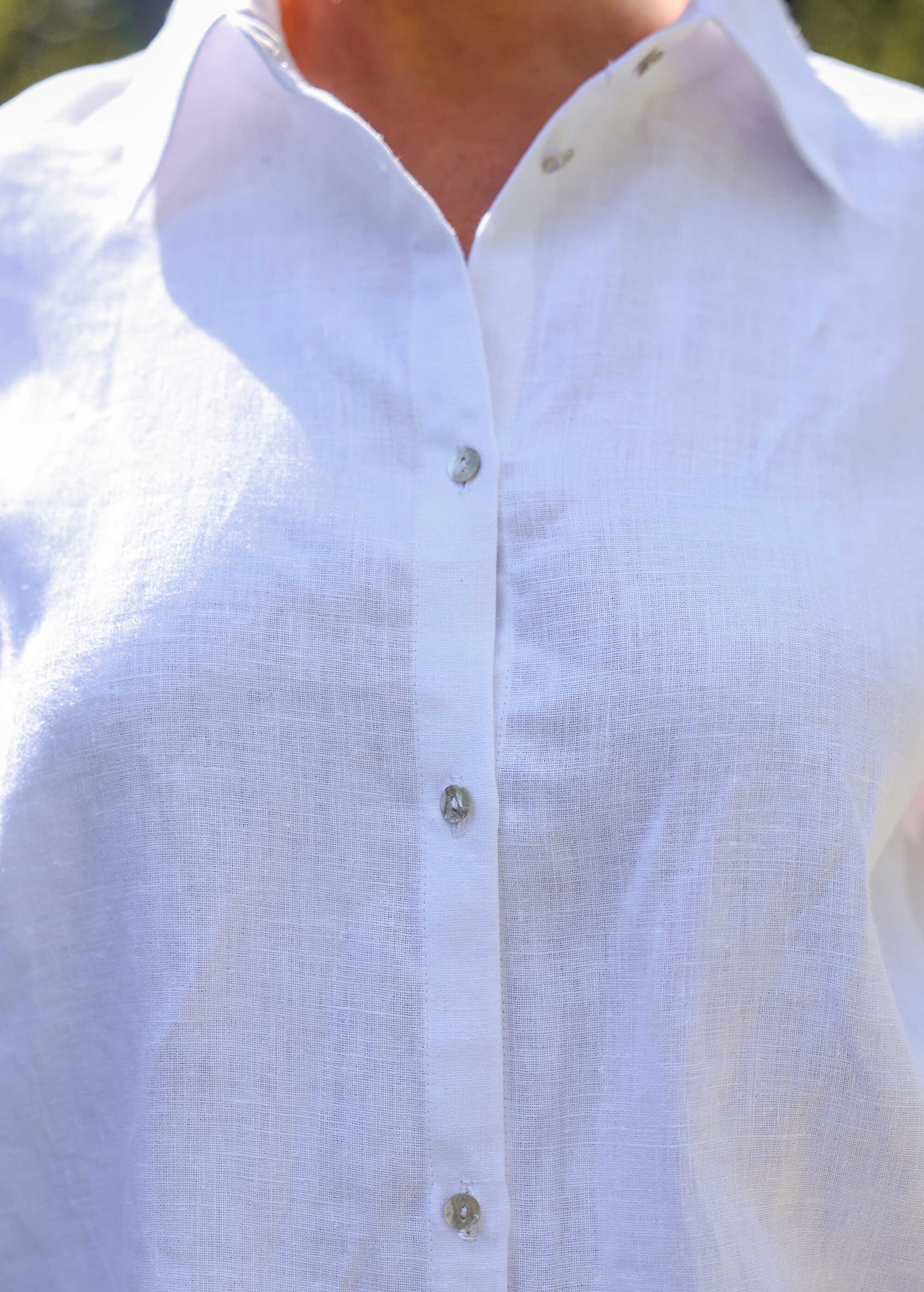 a close up of a person wearing a white shirt