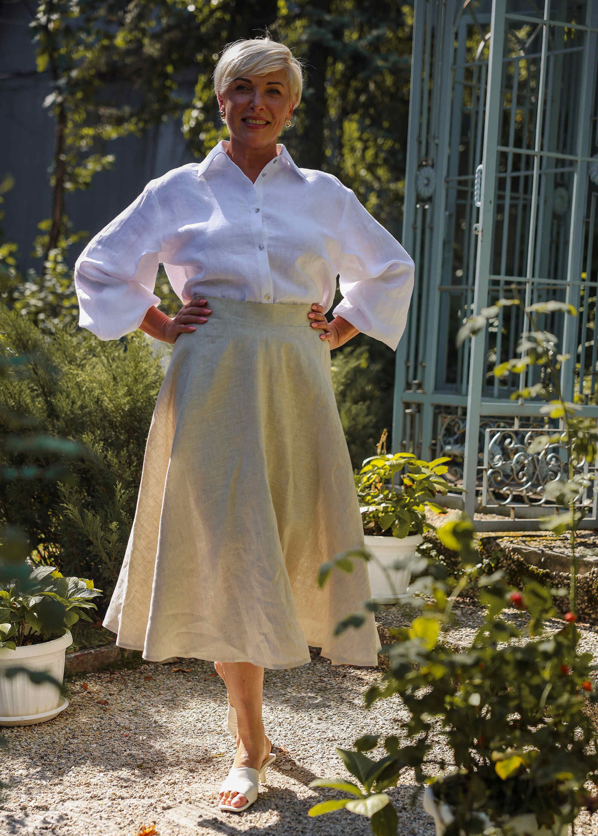 a woman in a white shirt and a yellow skirt