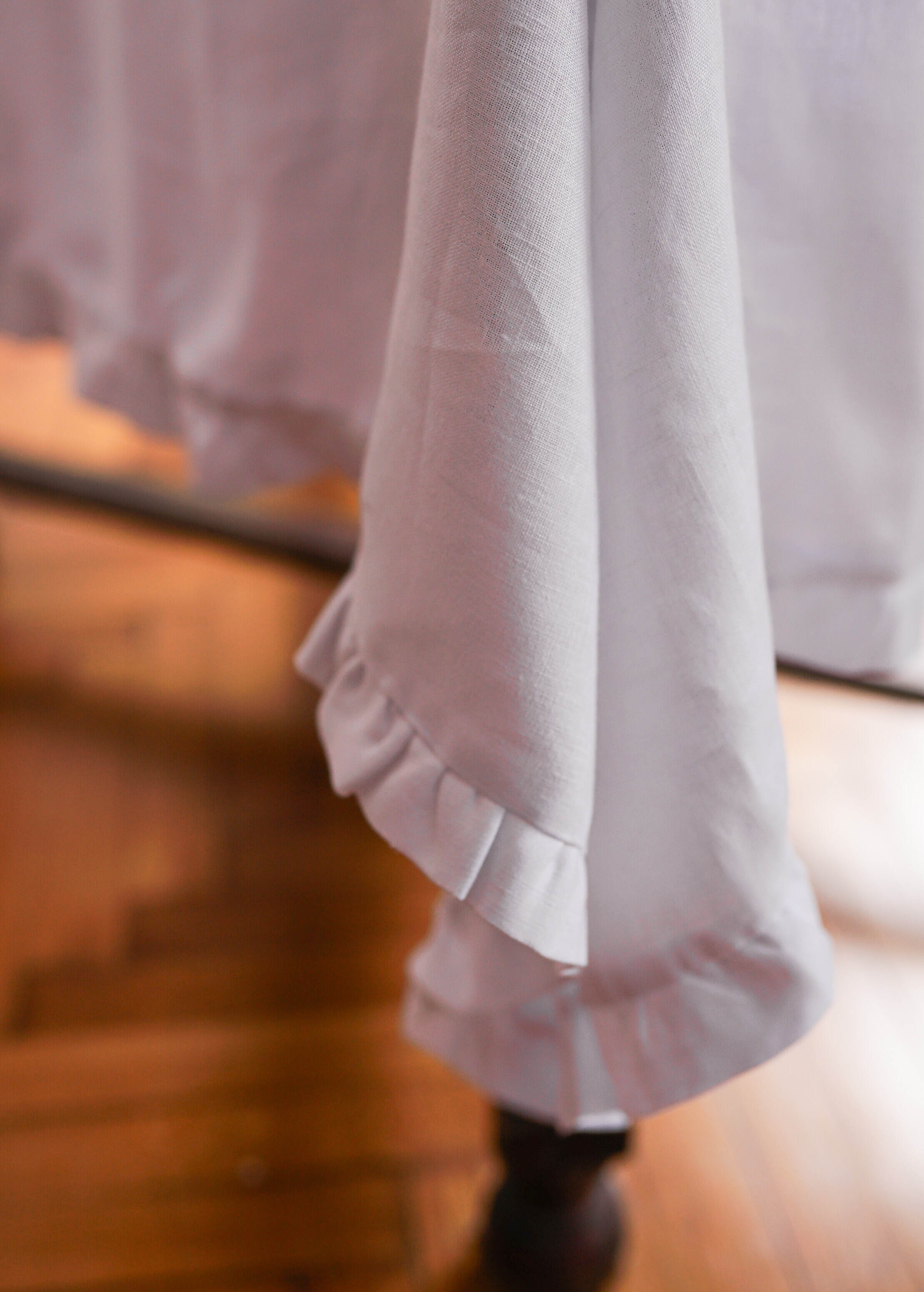 a close up of a bed with a white bedspread