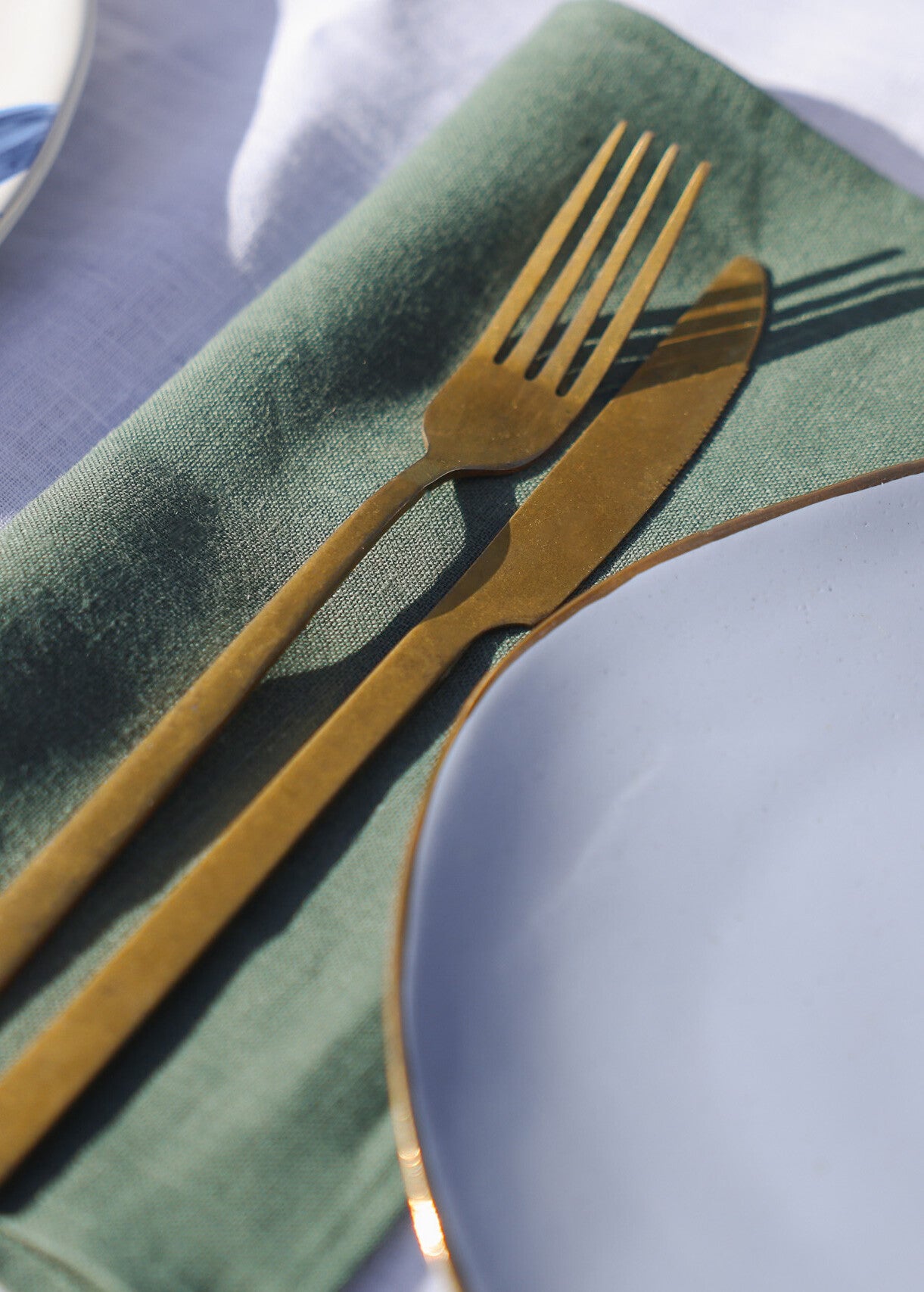 a close up of a fork and a plate on a table