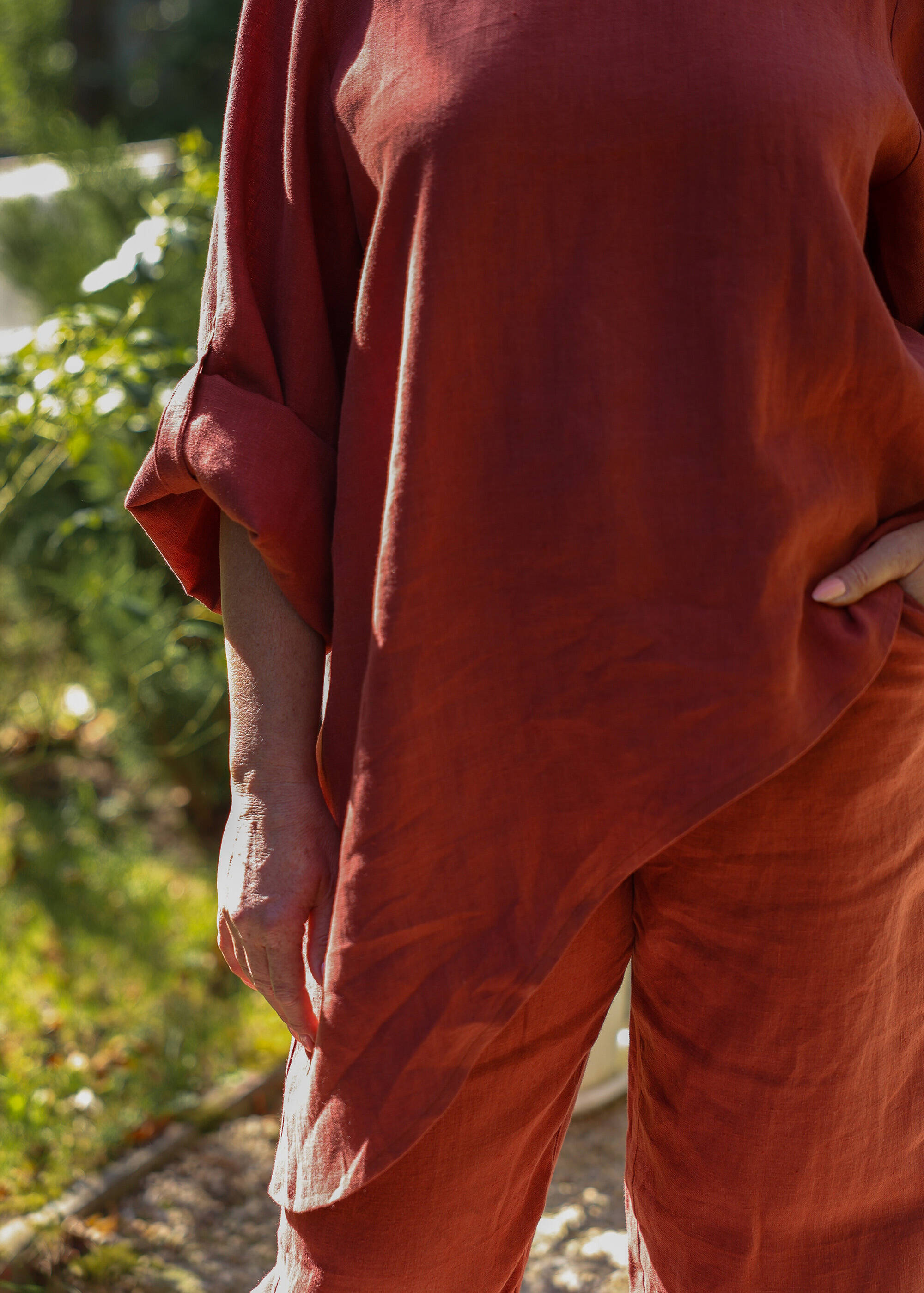 a woman wearing a red shirt and orange pants