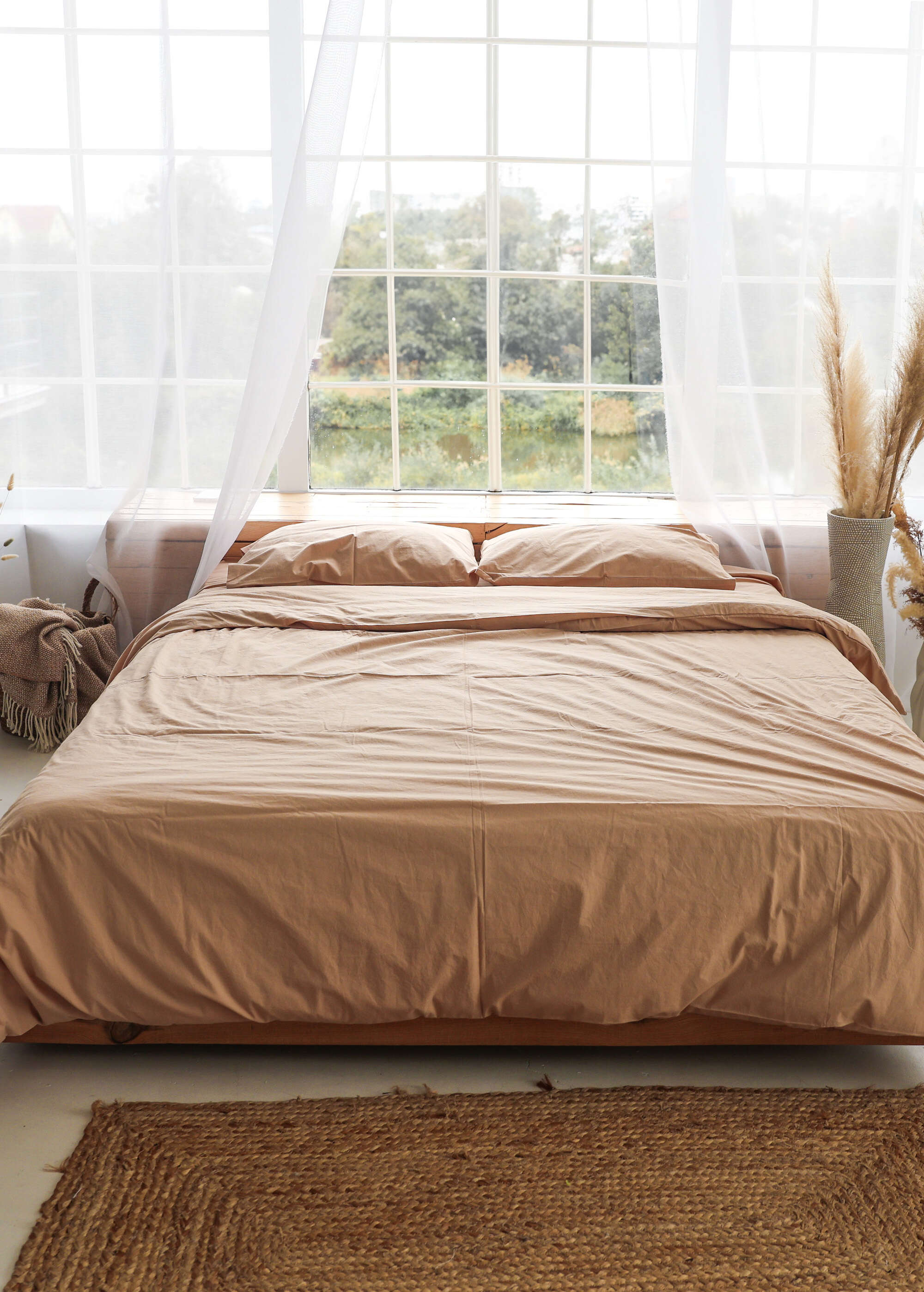 a bed sitting in a bedroom next to a window