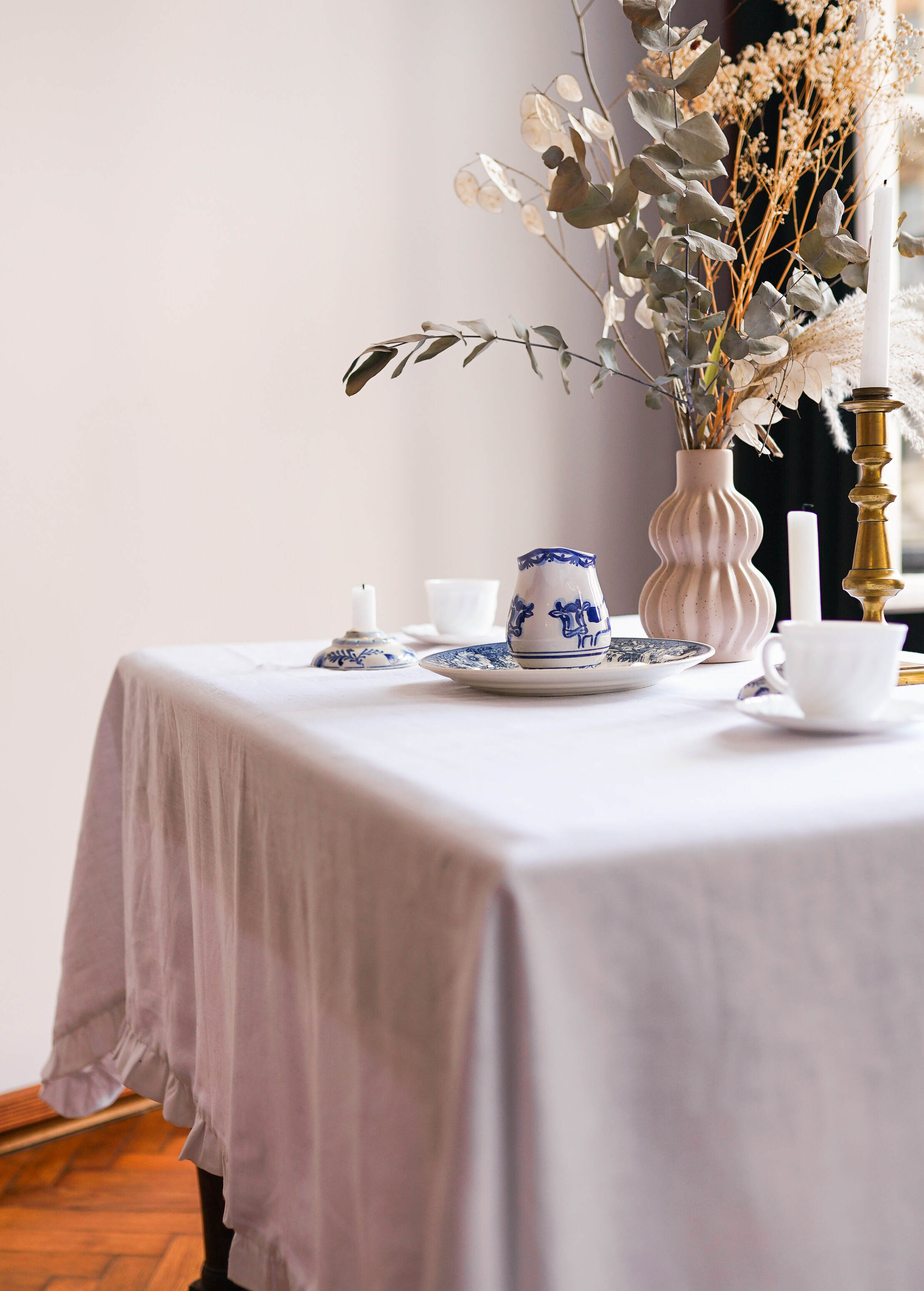 a table with a white table cloth and a vase of flowers