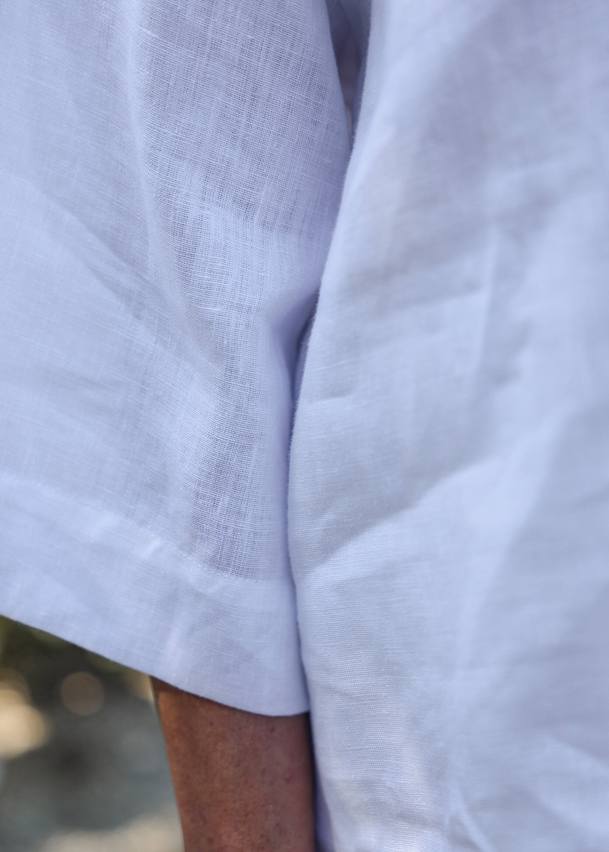 a close up of a person wearing a white shirt