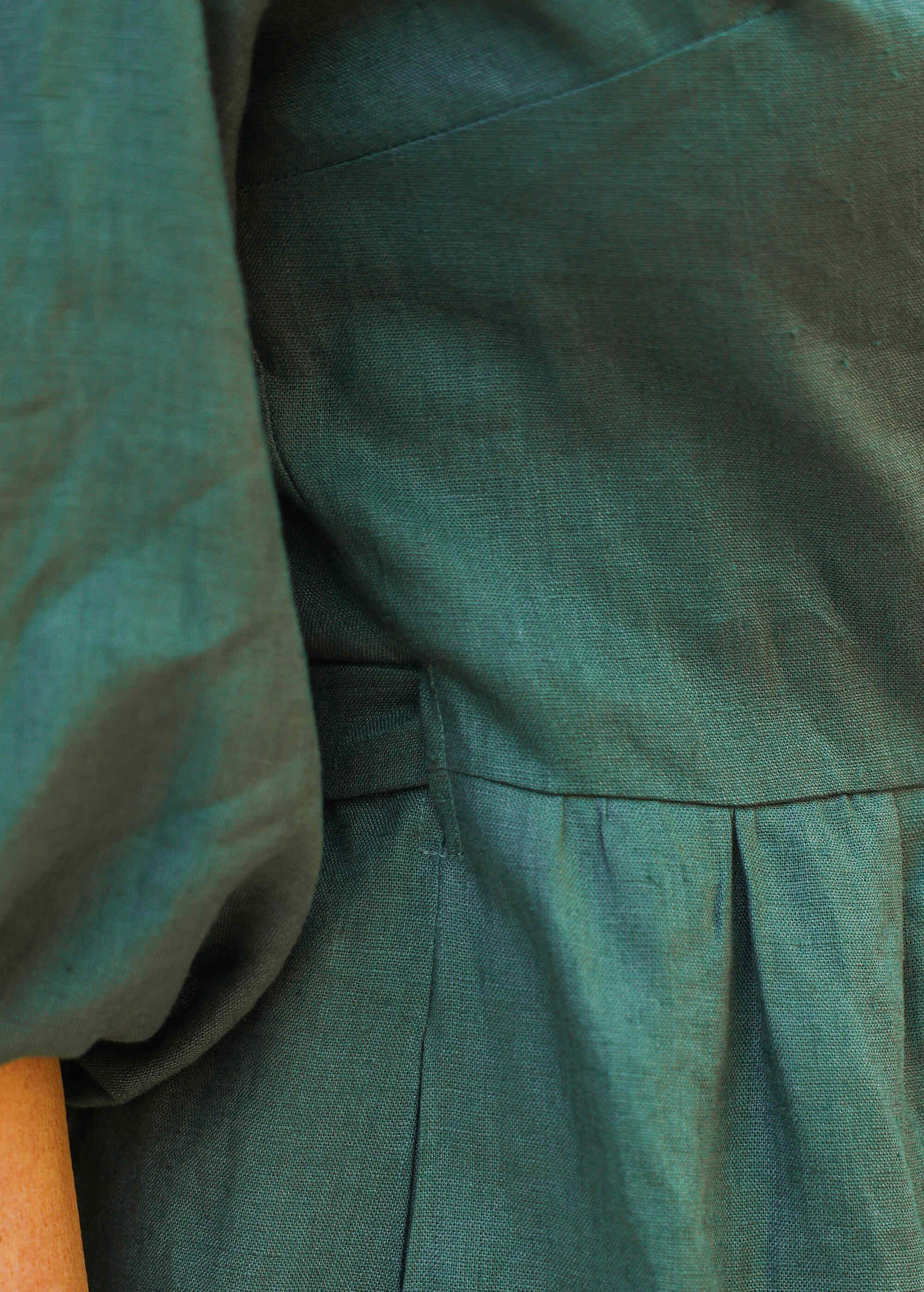 a close up of a person wearing a green dress