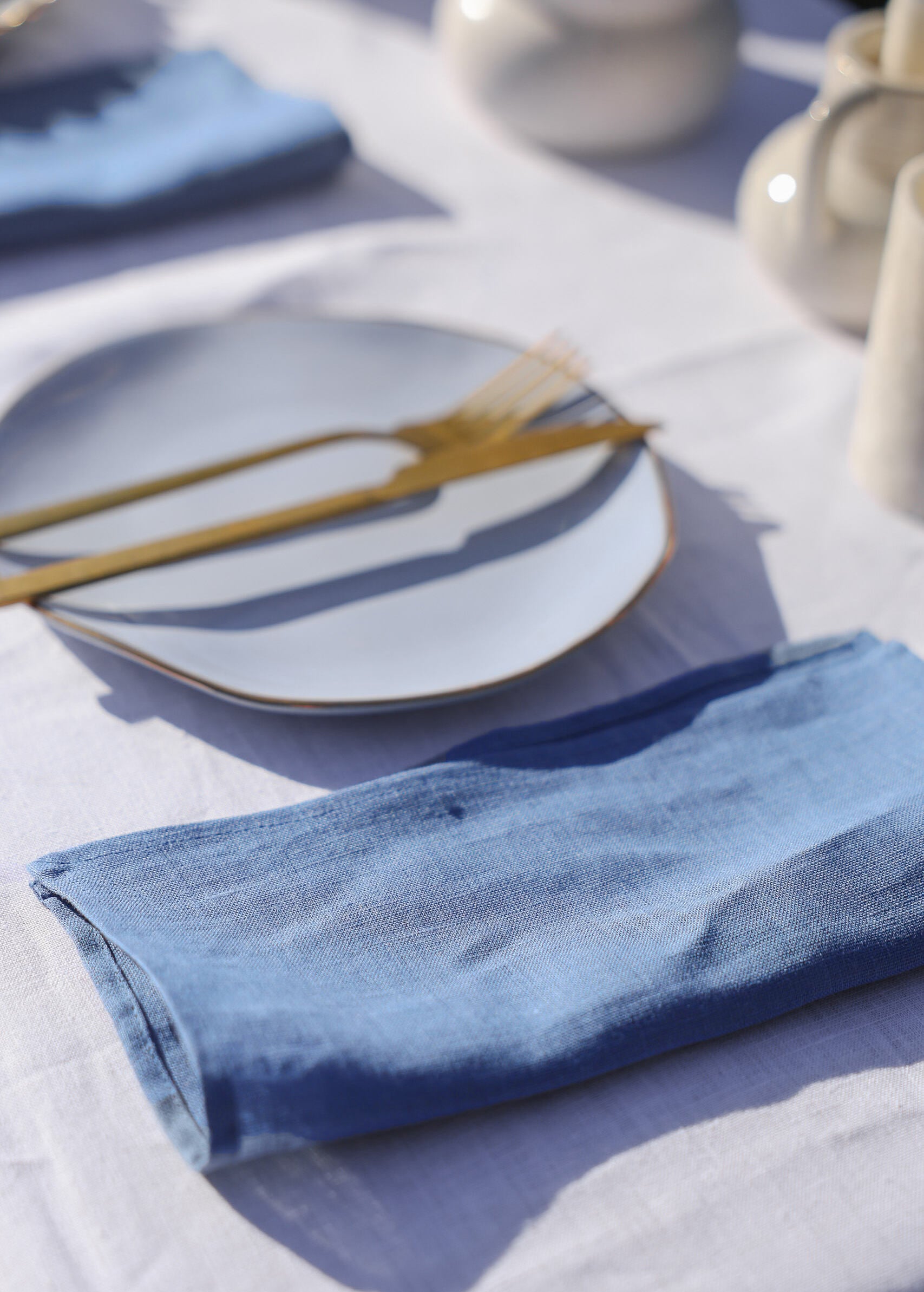 a white plate with a gold fork on it