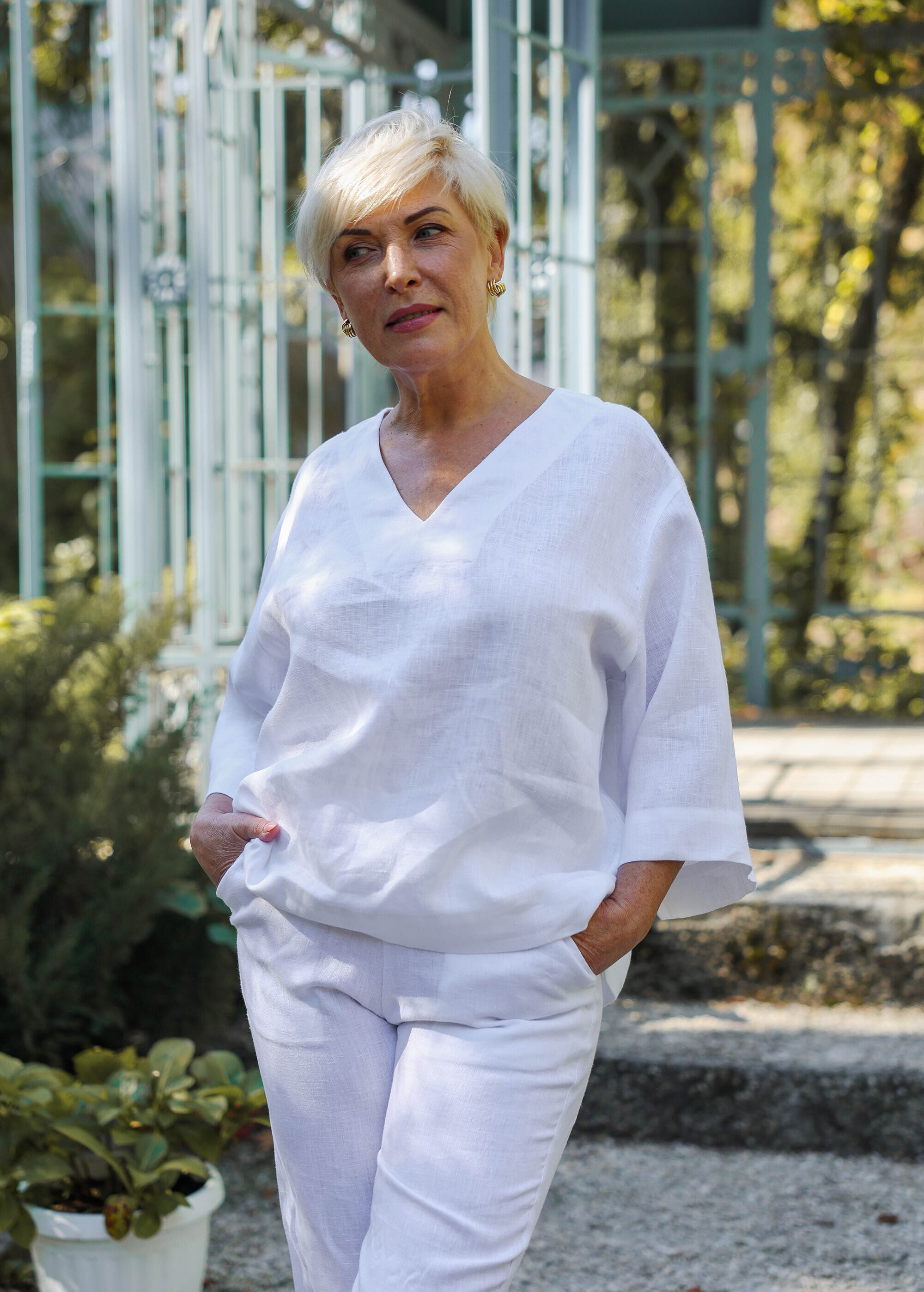 a woman in a white top and white pants