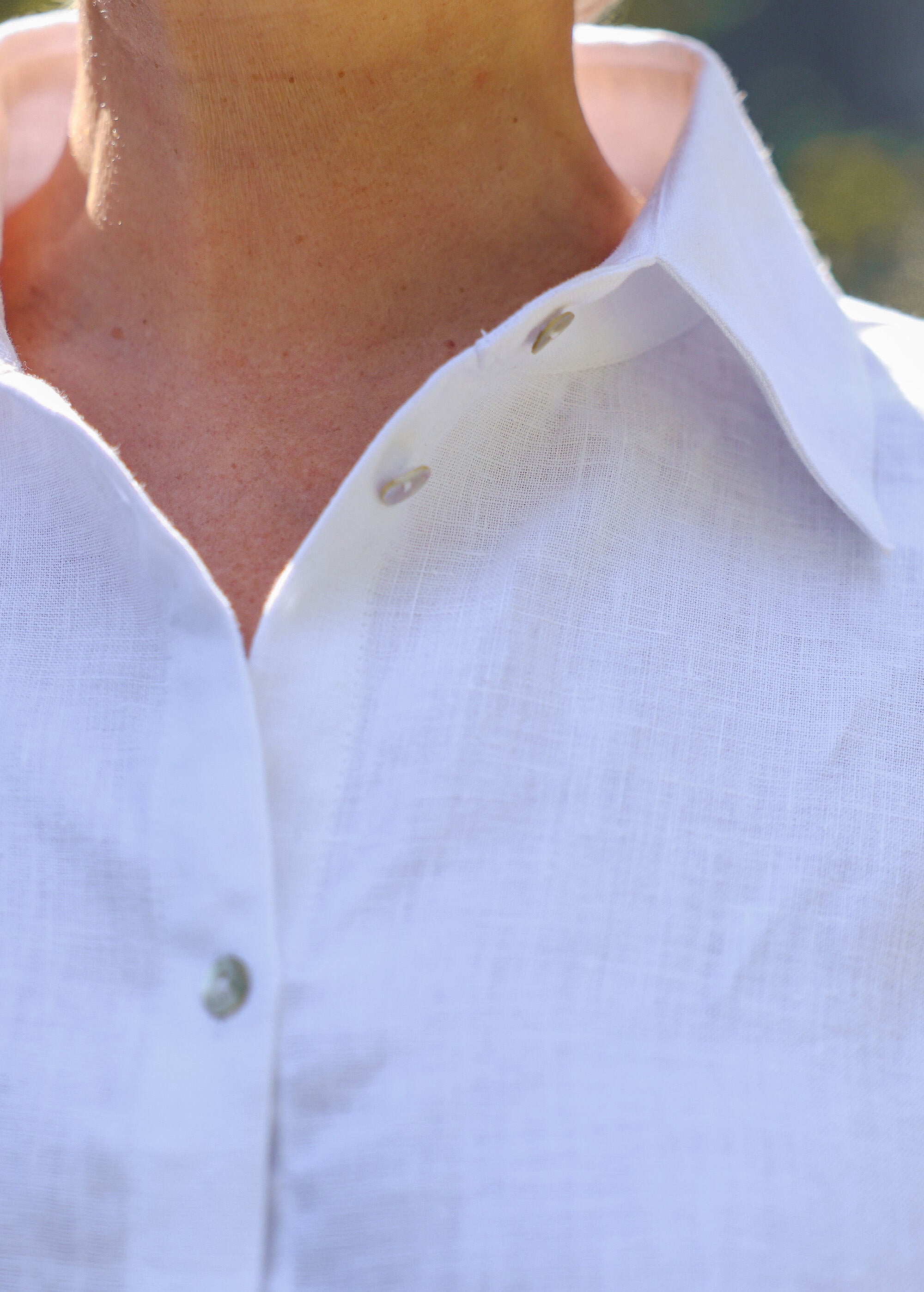 a close up of a person wearing a white shirt