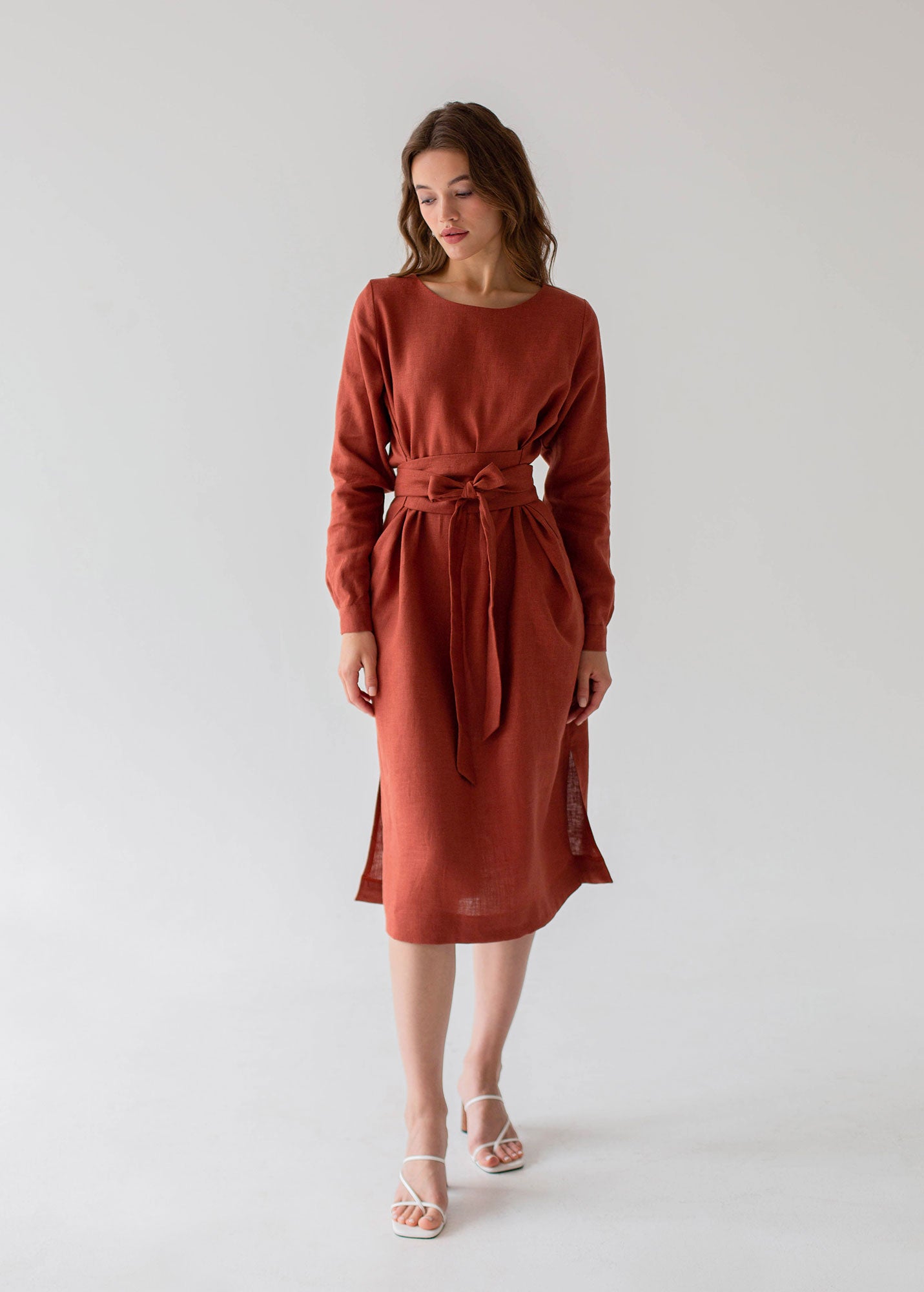 a woman in a red dress standing in front of a white background